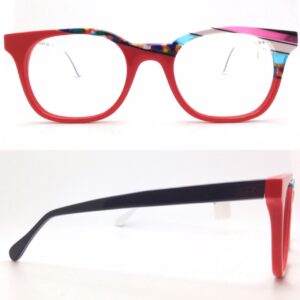bernard shear- ophthalmic, plastic, square, eyeglasses. multicolor/pattern, red, white, black, clear pink and baby blue, with multicolor splotch pattern, and black and white temples.