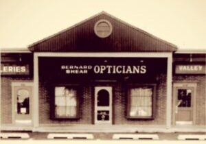 A black and white photo of Bernard Shear Opticians 1970 store front on Reisterstown Road in Owings Mills, MD