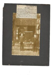 Two opticians standing in front of an optical store. Two opticians standing in front of an optical store.